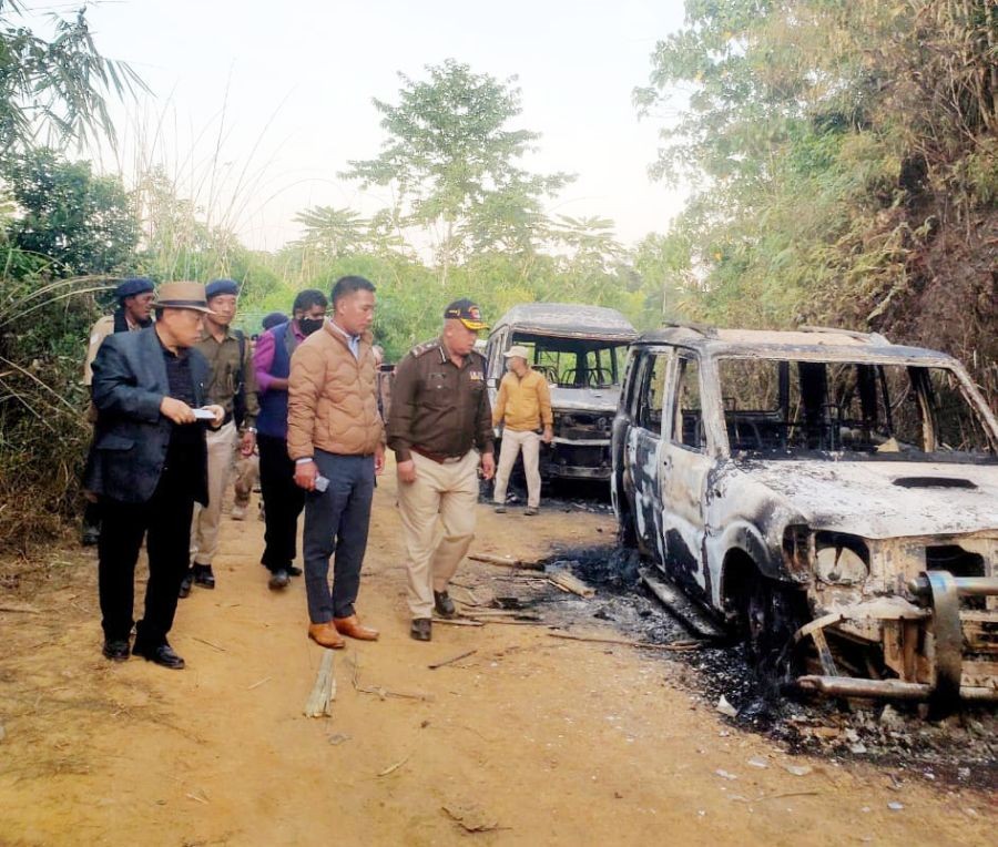 State government officials and police personnel inspect the charred remains of vehicles belonging to security personnel involved in the Oting killings of December 2021. (File Photo: Twitter)